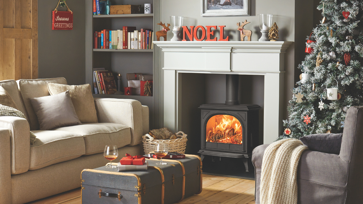 A stove and fireplace decorated with Christmas decorations